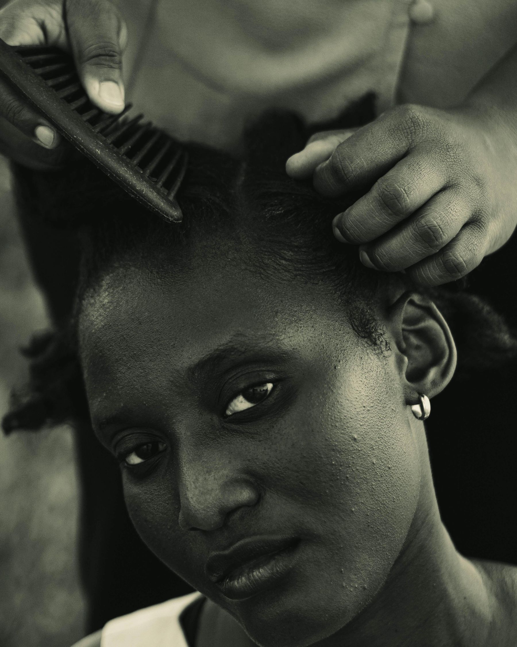 Black and white portrait of a woman having her hair styled
